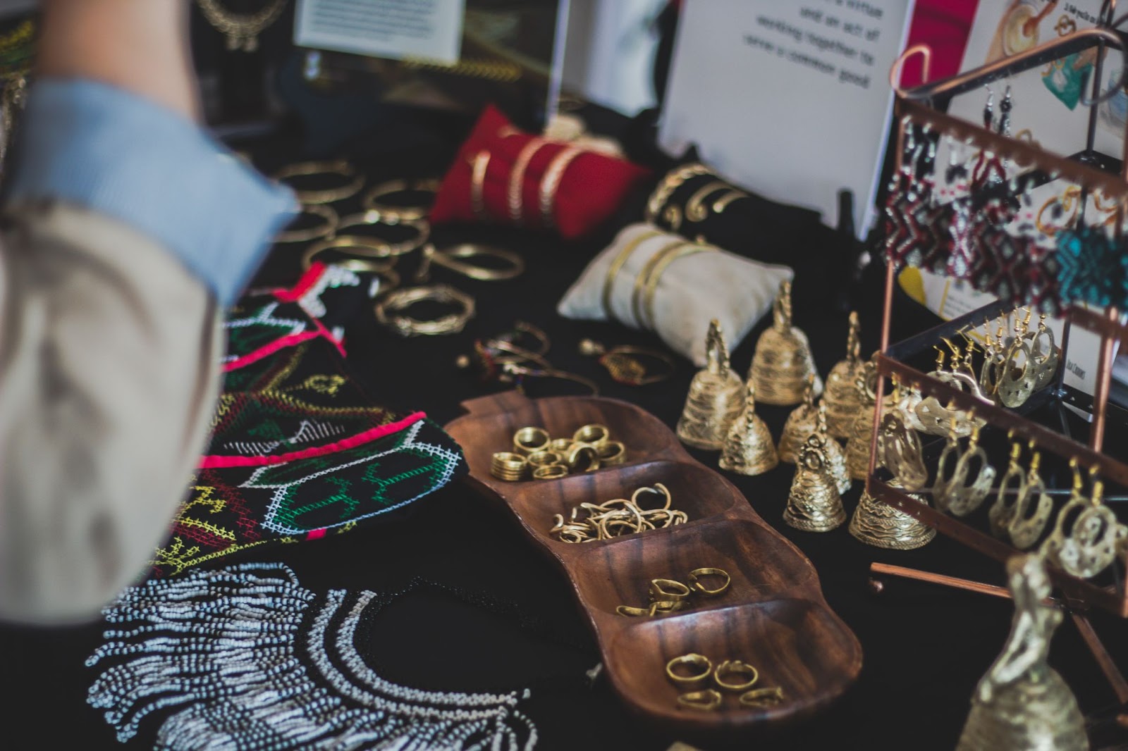 A jewelry collector goes through her gold jewelry to determine which pieces she wants to accessorize with today