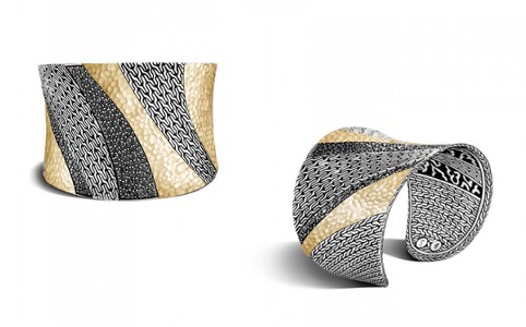 A black stainless steel and yellow gold geometric and bold cuff