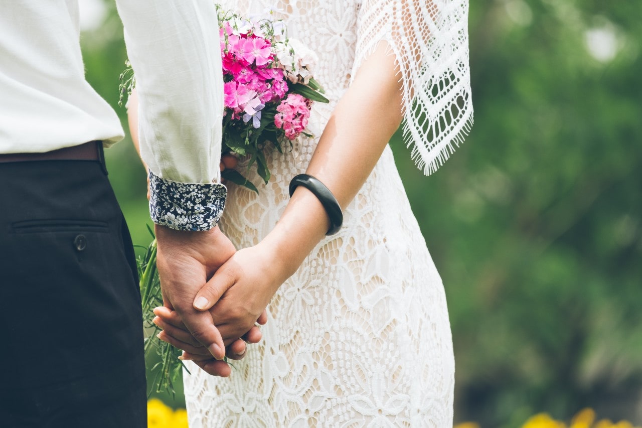 Newly weds holding hands