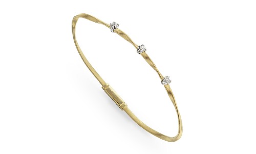 Bangle with distinctive textured metalwork and diamond accents by Marco Bicego