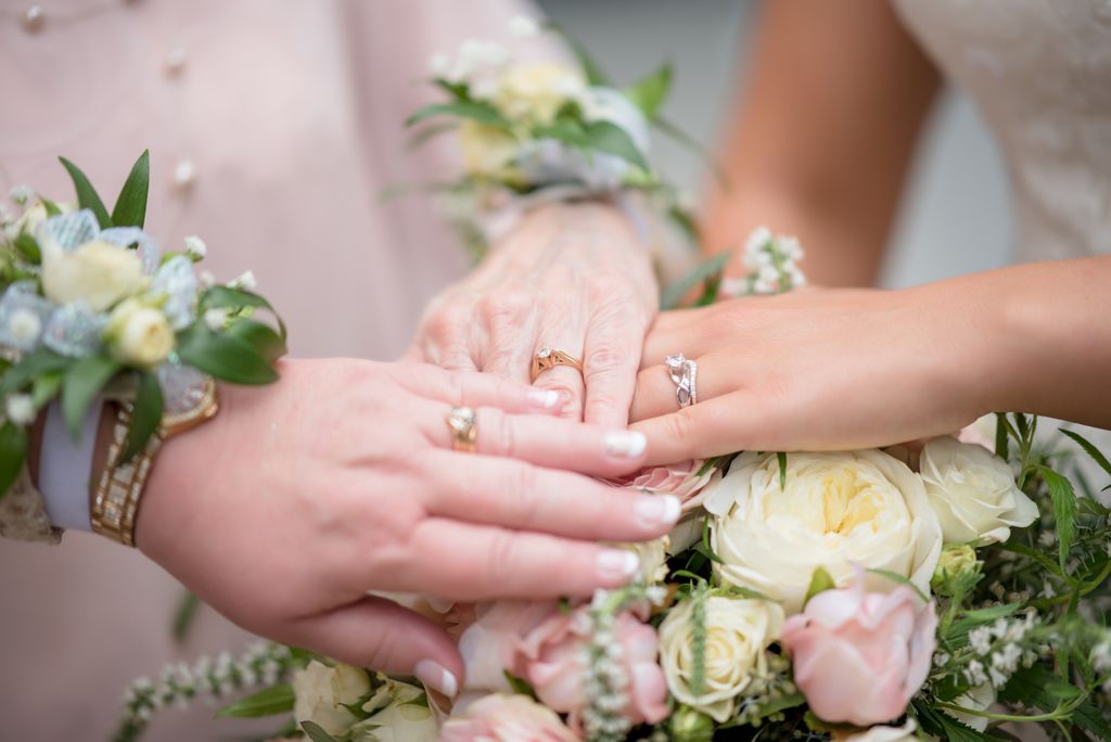 A group of brides compares their engagement rings