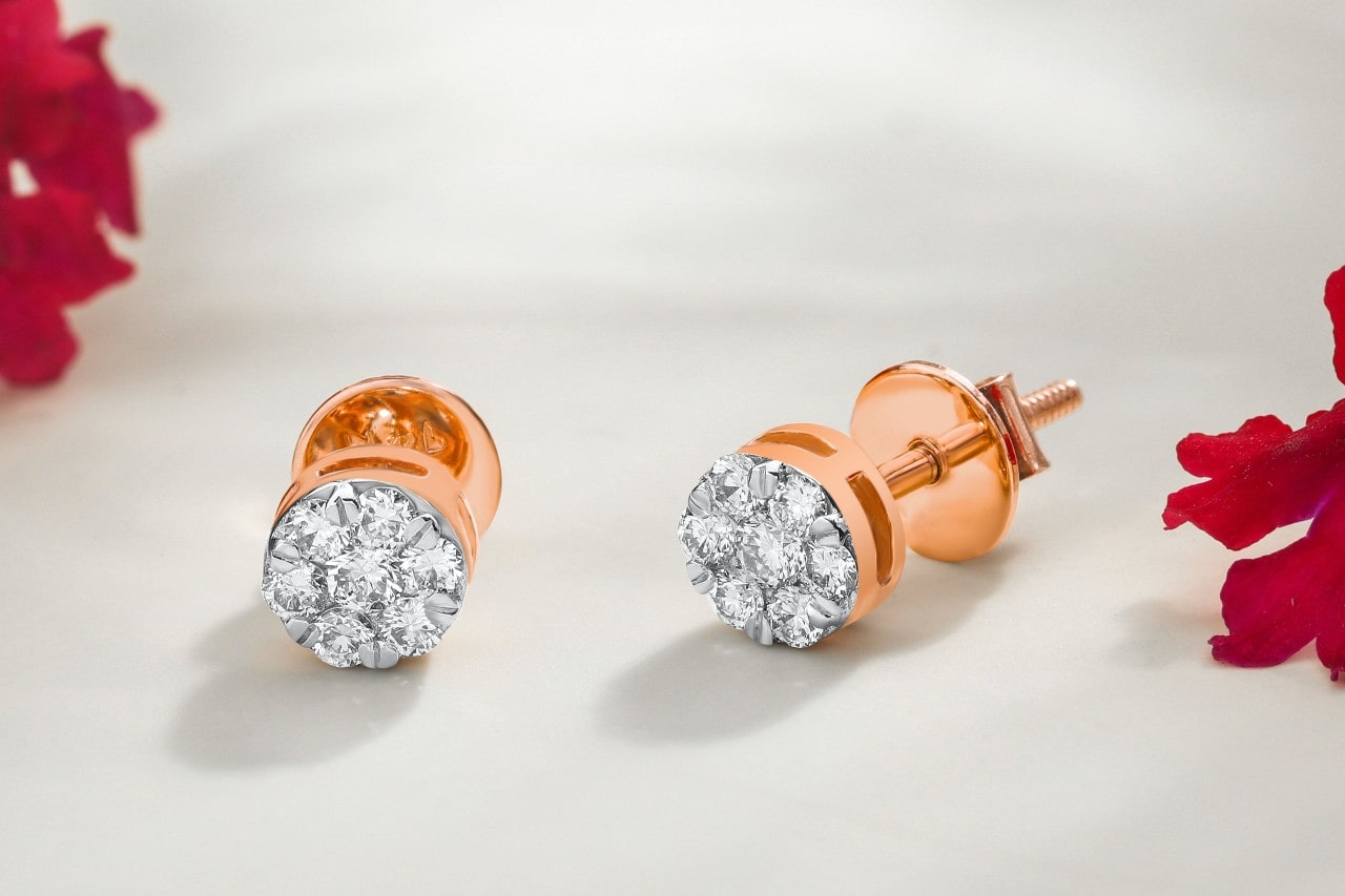 A close-up of a pair of simple yet elegant diamond stud earrings.