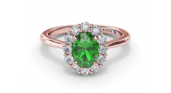 a rose gold halo fashion ring featuring an emerald center stone by Fana