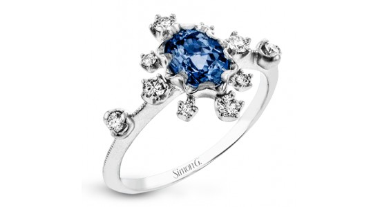 a white gold fashion ring featuring a sapphire center stone and diamond accents