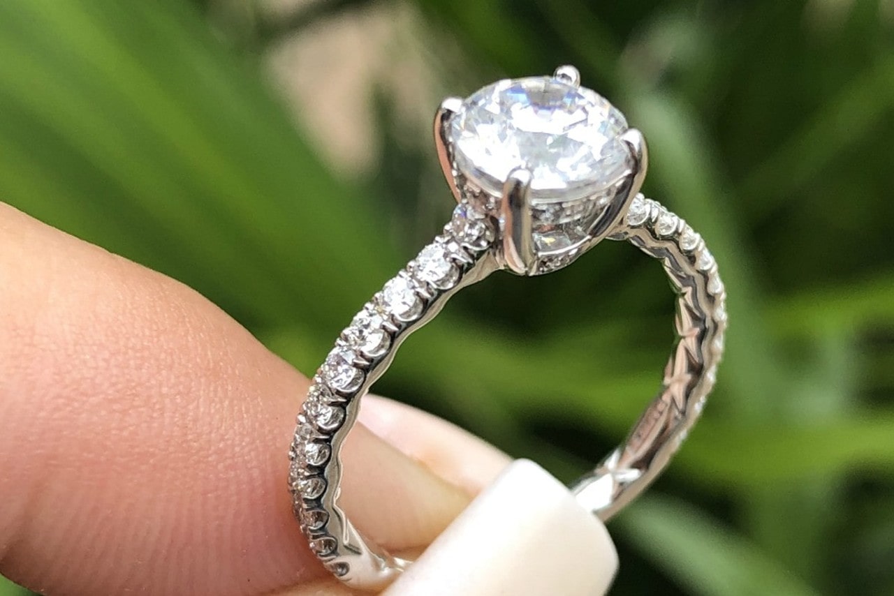 An elegant engagement ring featuring diamond accents along the band.