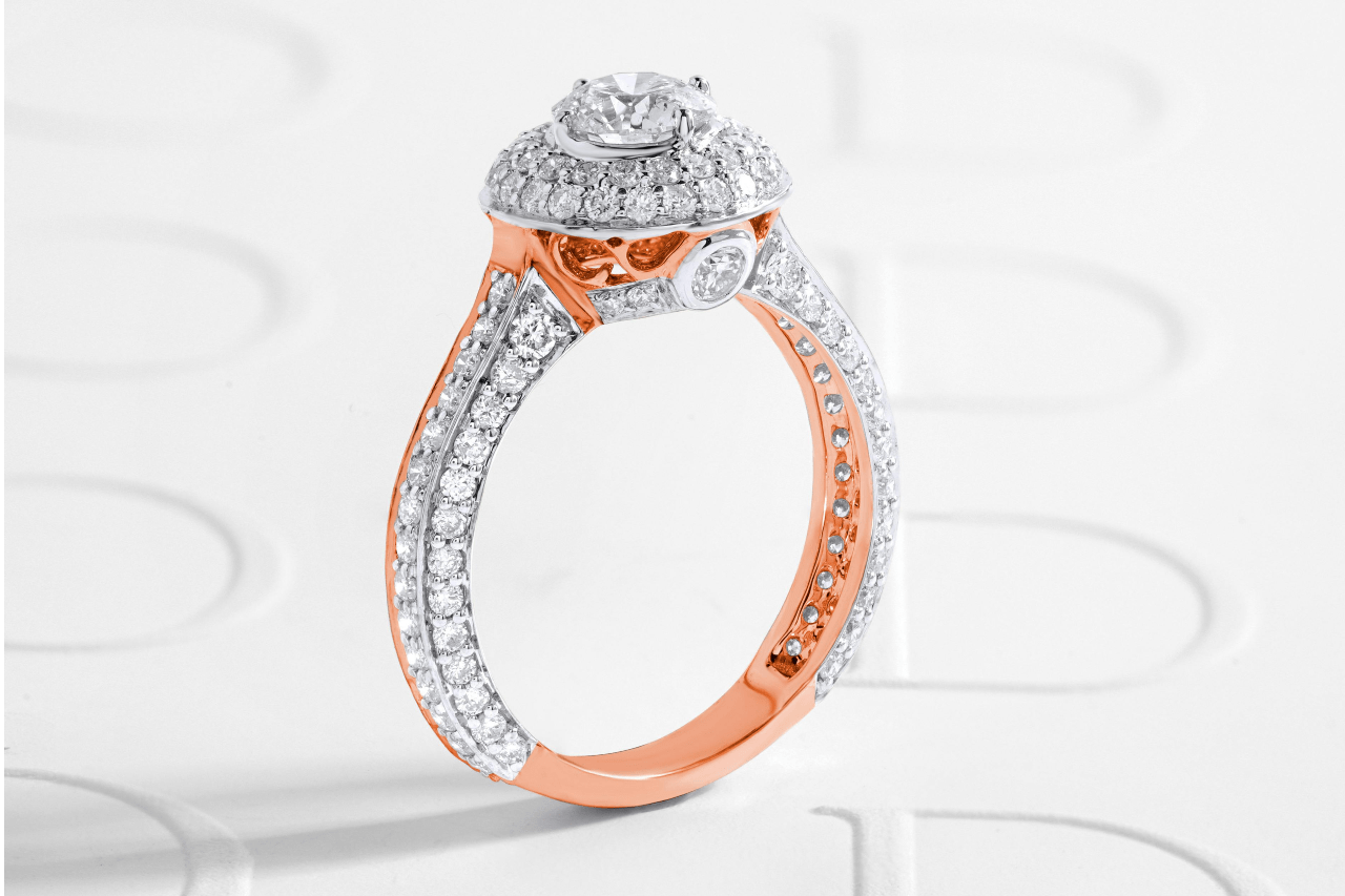 a diamond and rose gold engagement ring on a white background