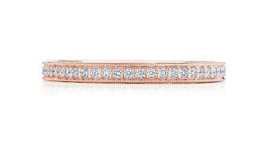 a rose gold diamond eternity ring with milgrain detail.