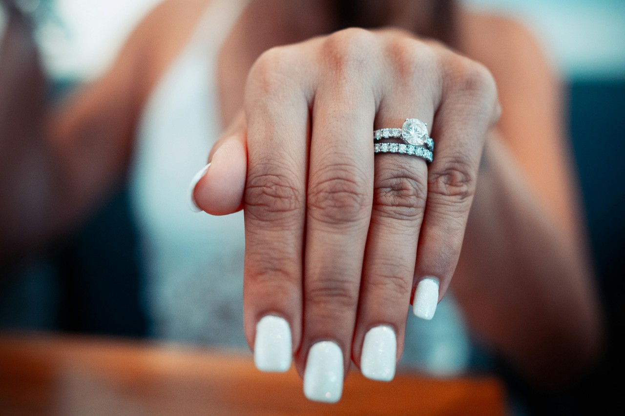 A close-up of a bride-to-be’s hand, adorned with a stunning engagement ring.