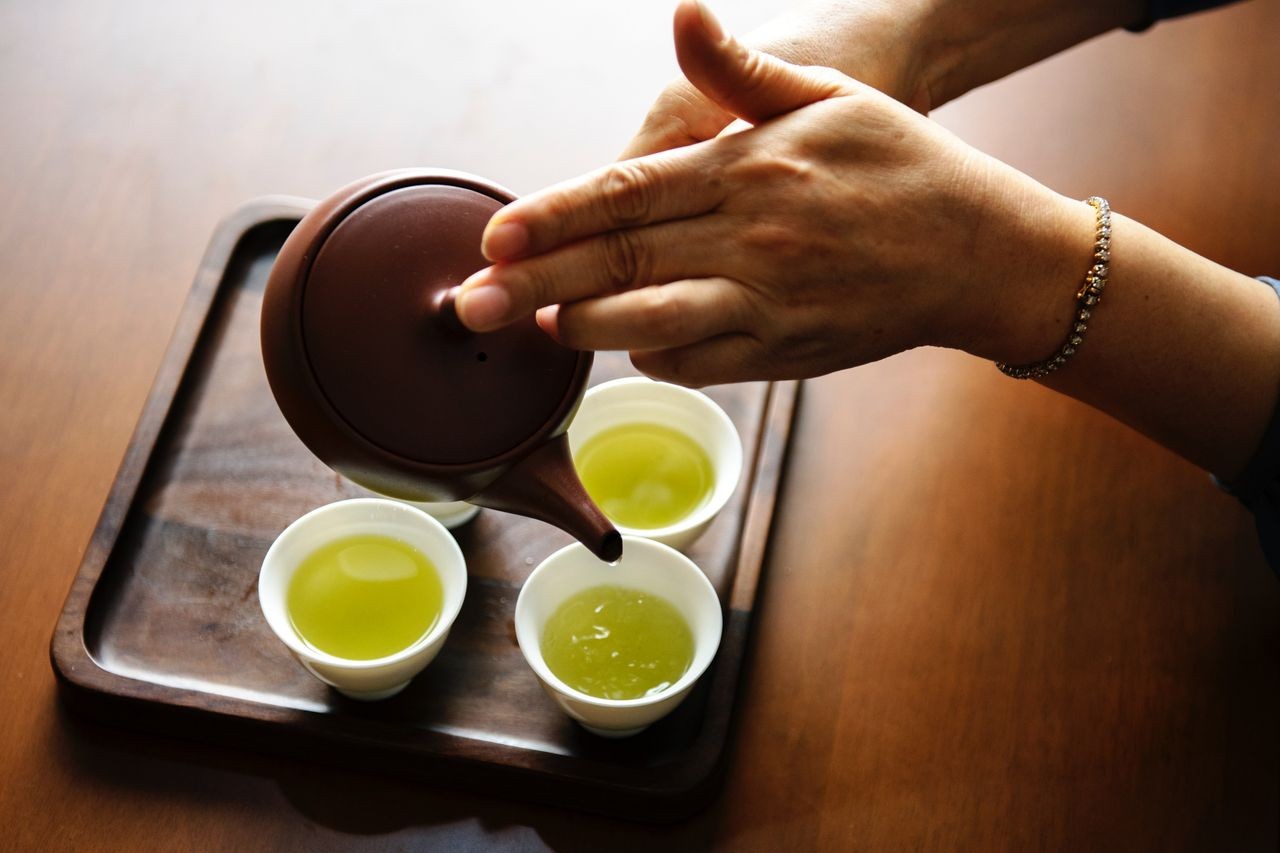 diamond bracelet holding tea